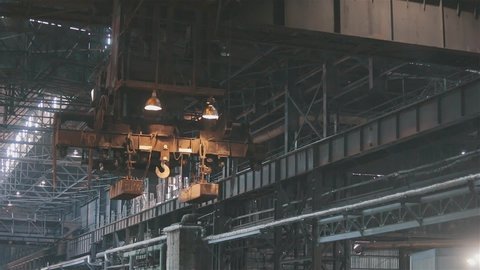Overhead crane movement in a factory. Overhead crane in a factory. Pavement crane at a large factory.