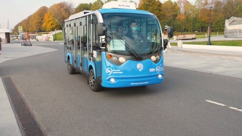 Moscow, Russia, 2021.10.03: A blue minibus is driving down the road. A small electric bus moves towards it