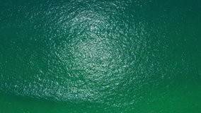 Aerial view video of disturbed blue ocean water surface. 4K 10bit 4:2:2