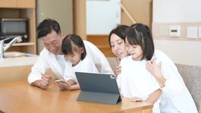 Parent and children looking at the screen of the tablet PC