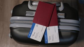 Close-up of a mobile phone with an international certificate of vaccination against covid-19 on a suitcase with passports and plane tickets. Personal QR code with encrypted information. - Powered by Shutterstock - Get 15% off with code: PIKWIZARD15