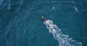Aerial view of a sailboat in sea. Sailing speed boat in ocean waves.