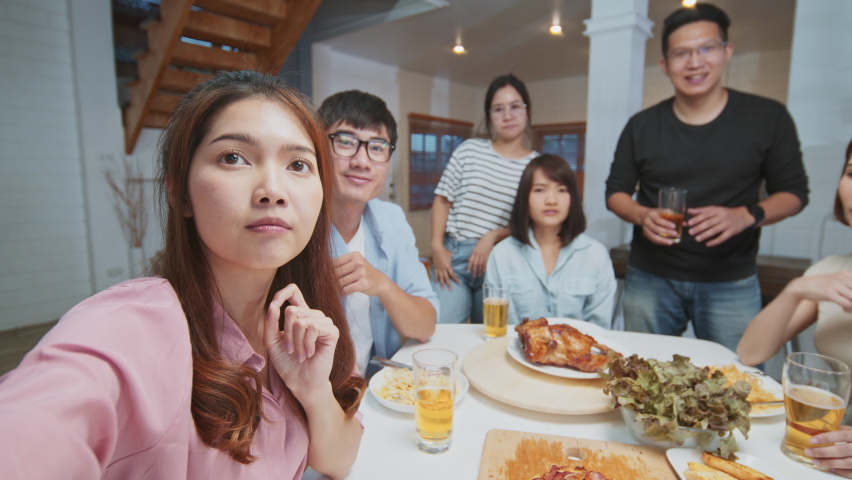Group of young Asian people on video call remote meeting at home. Family and friends online gathering, internet communication information technology, or coronavirus social distancing lifestyle concept Royalty-Free Stock Footage #1080523226