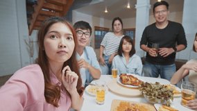 Group of young Asian people on video call remote meeting at home. Family and friends online gathering, internet communication information technology, or coronavirus social distancing lifestyle concept