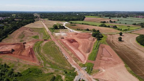 Construction site for HS2 high speed railway route destroying beautiful Warwickshire countryside. Diggers. Ariel landscape.