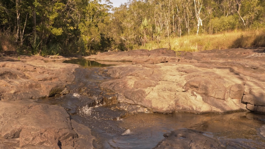 Stream Flowing Down On Rocky Stream During Dry Season Near Cedar Creek Falls In Proserpine, Australia. - wide static