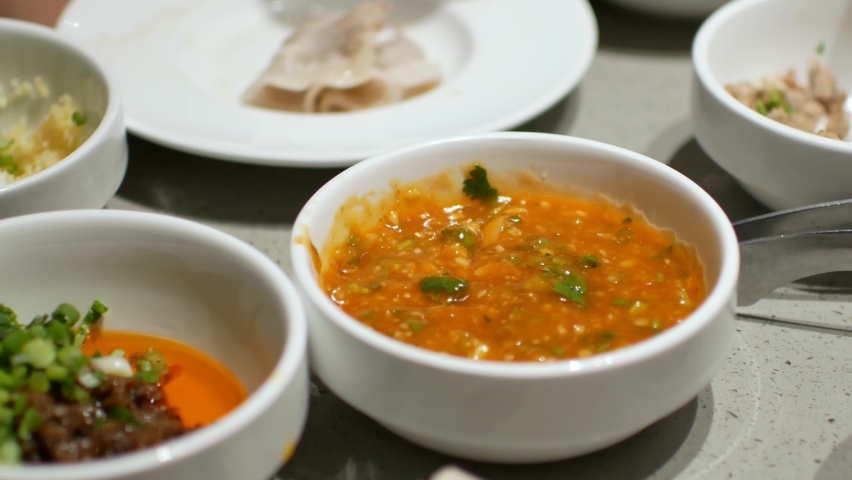 4k video POV while putting pork slice fron hotpot shabu dipping into the sauce. Chinese japanese food