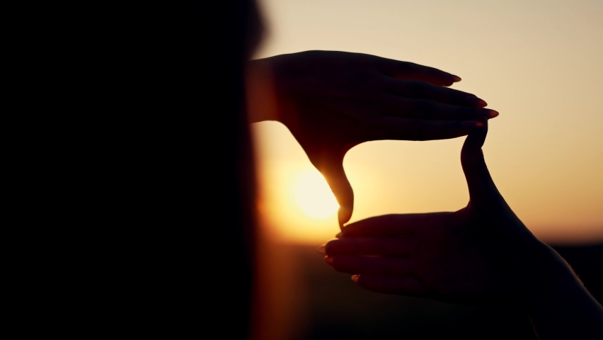 Business strategy. Girl folded her hands in frame at sunset. Silhouette of girl in natural park. Fingers at sunset. Work planning. Girl in field folded her hands into frame. Business planning concept. Royalty-Free Stock Footage #1080534326