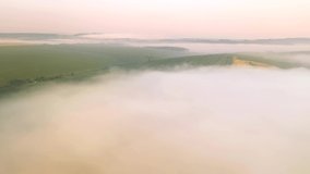 Shooting from a drone of a foggy agricultural lands. Cinematic aerial shot. Location place of Ukraine agrarian region, Europe. Ecology concept. Discover the beauty of earth. Filmed in 4k, drone video.