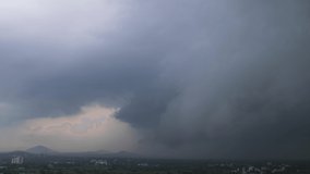 Spectacular cloud formation, thunderstorms, lightning, heavy rain in the valley. Time lapse video. Pune, India.
