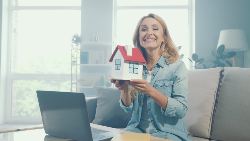 Cheerful nice glad lady enjoy relocation proposition hold paper house