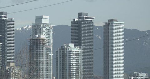 Burnaby BC high rise buildings with mountains in background.