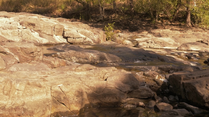 Low Water Level During Summer Season Flowing Into Cedar Creek Falls On A Sunny Day. - wide shot