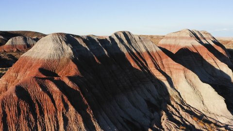 Teepees of Painted Desert with blue sky at Arizona - aerial drone flying shot