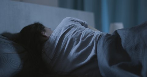 Stressed woman suffering from insomnia at night, she can't fall asleep Arkivvideo