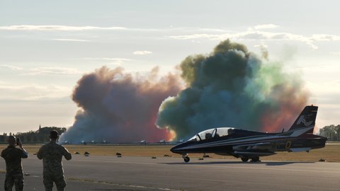 Rivolto Italy SEPTEMBER, 17, 2021 Aermacchi MB-339 of Frecce Tricolori. Static view colorful smoke cloud with spectators watching the air show of aerobatic squadron. Blank space background