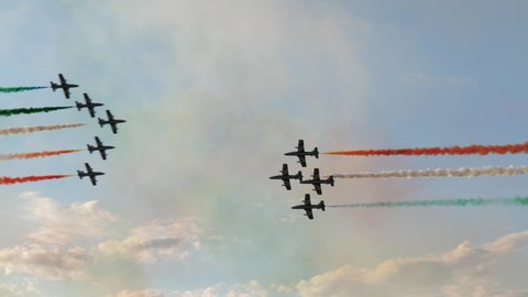 Rivolto Italy SEPTEMBER, 17, 2021 Aermacchi MB-339 of Frecce Tricolori. Two groups of jet airplanes crossing in the sky fast on air show with red green and white smokes of italian flag