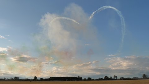 Rivolto Italy SEPTEMBER, 17, 2021 Aermacchi MB-339 A PAN of Frecce Tricolori. Scenic panorama two formations of jet planes with white contrails drawing heart symbol of love in blue sky