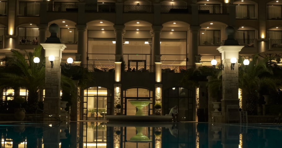 Calm night hotel. A nice bright summer hotel during night time. Royalty-Free Stock Footage #1080564710