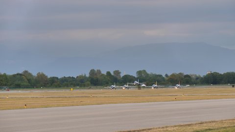 Rivolto Italy SEPTEMBER, 17, 2021 Panning view five jet planes landing together on runway on airshow. Rare military aircrafts formation landing. Aermacchi MB-339 of Frecce Tricolori.
