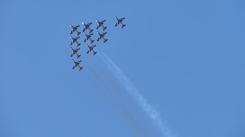 Rivolto Italy SEPTEMBER, 17, 2021 Aermacchi MB-339 of Frecce Tricolori. Ground view group of ten jet planes fast fly synchronised together forming triangle on air-show with blue sky background.