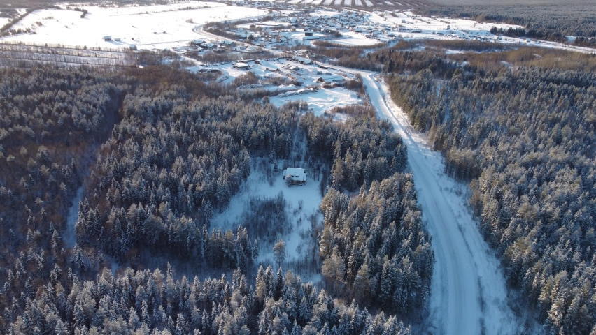 Aerial view from a drone of a small village, winter landscape, frosty sunny day, everything is covered with snow, 4k video with a beautiful flare | Shutterstock HD Video #1080571337