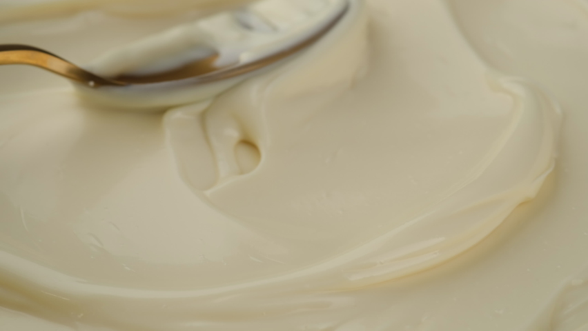 Mayonnaise sauce with golden spoon. Sour cream with spoon, fresh greek yogurt close up. 4K UHD video Royalty-Free Stock Footage #1080573734