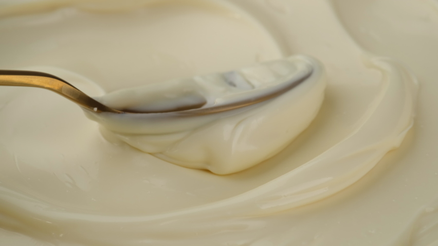 Mayonnaise sauce with golden spoon. Sour cream with spoon, fresh greek yogurt close up. 4K UHD video | Shutterstock HD Video #1080573734