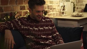 Young adult man showing Christmas present and chatting. Shot with RED helium camera in 8K