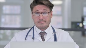 Close Up of Doctor with Laptop Shaking Head as No Sign - Powered by Shutterstock - Get 15% off with code: PIKWIZARD15