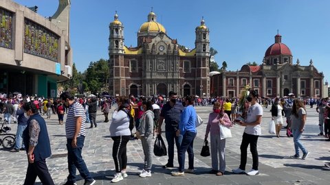 Mexico City, Mexico - October 10, 2021: People wear face masks to protect from COVID-19 pandemic as they visit the sacred Basilica Virgin of Guadalupe during a sunny weekend.
