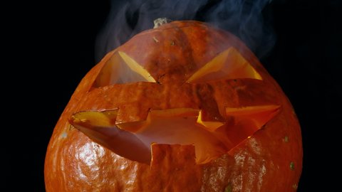 Jack O Lantern Halloween Pumpkin Blows Out Smoke Dark Background .Halloween Concept
