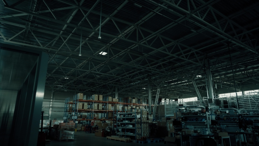 Turning on the lights in the warehouse. Turning on lighting in a large warehouse. Empty shelves, Royalty-Free Stock Footage #1080588542
