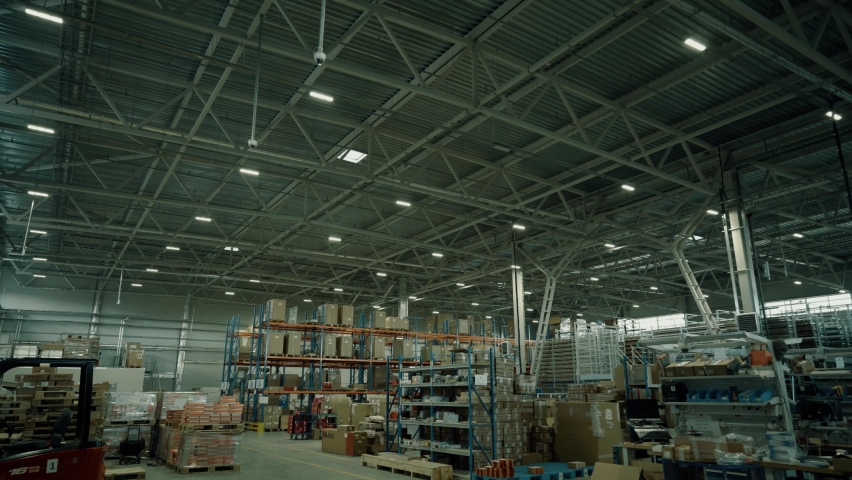 Turning on the lights in the warehouse. Turning on lighting in a large warehouse. Empty shelves, Royalty-Free Stock Footage #1080588542