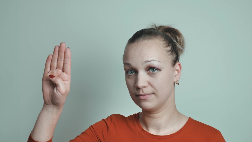 The woman shows a gesture of help to the palm and asks for help Royalty-Free Stock Footage #1080592463
