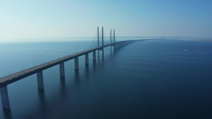 Panoramic aerial view of the Oresundsbron bridge between Denmark and Sweden. Close up view of the Oresund Bridge on a clear sunny day.	 Royalty-Free Stock Footage #1080595418