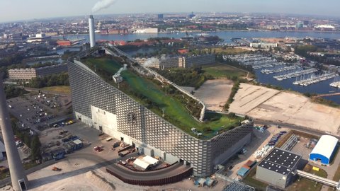 Copenhagen, Denmark. June 10, 2021. Aerial view of the Amager Bakke, Copenhill Waste-to-Energy Power Plant in Copenhagen with the ski area on the roof.	