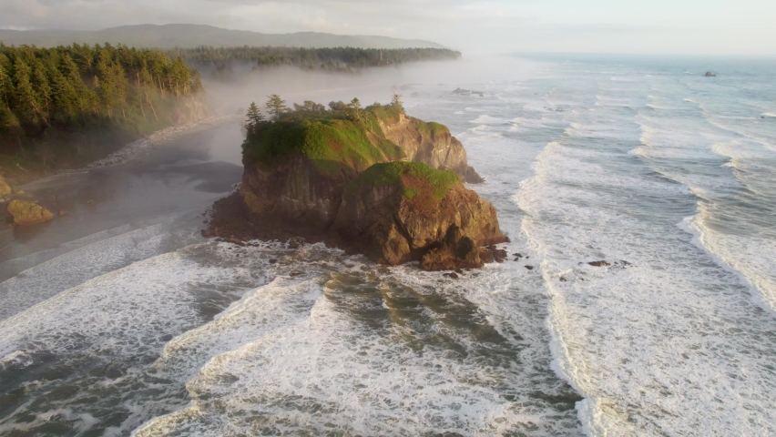 Flying over Ruby beach, Oregon, United States. Pacific waves and huge stones on the shore in sunset light. Aerial view of Pacific coast in USA | Shutterstock HD Video #1080596054
