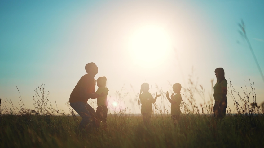 people in the park. happy family playing in the park silhouette. father throws up playing with daughter. happy family kid dream concept. friendly family in the park fun playing picnic Royalty-Free Stock Footage #1080596942