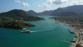 Aerial drone video of iconic port of Nidri or Nydri a safe harbour for sail boats and famous for trips to Meganisi, Skorpios and other Ionian islands, Lefkada island, Ionian, Greece
