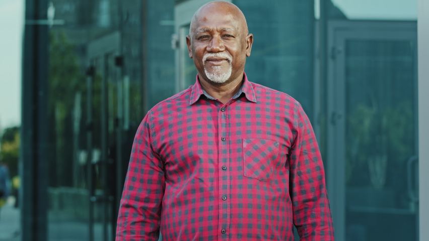 Portrait Elderly African American man with gray beard standing outdoor with arms crossed on chest, nonverbal communication concept, closeup adult person of retirement age showing gesture confidence Royalty-Free Stock Footage #1080599486