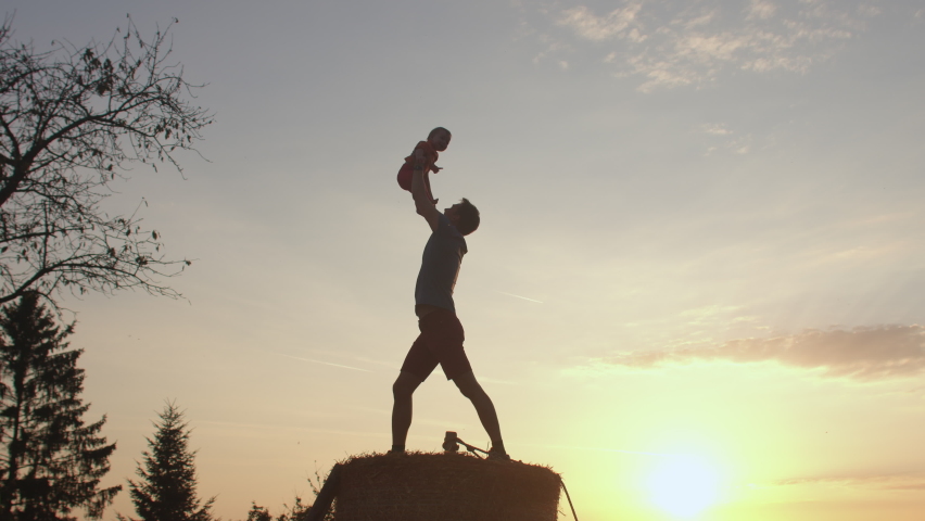 Silhouette father with baby in arms. Joy kissing baby Pride of fatherhood positive parenting Relationship between parent child. Healthy lifestyle Building strong communication with children lifestyle. Royalty-Free Stock Footage #1080600116