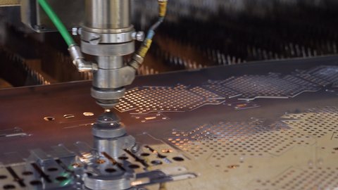 Modern machine laser metal sheet cnc cutting steel plate. High precision cutting machine metal plate. Burn laser cutter work steel products. Automated machine CNC laser cutting metal part. Metalwork