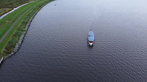 GRONINGEN, NETHERLANDS - 23. SEPTEMBER 2021: Drone footage of a Boat driving in the Paterswoldsemeer, a large lake in the south of Groningen, Netherlands 4k