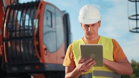 worker in hard a hat with digital tablet near excavator. construction site driver with online digital tablet. industry construction concept. worker hard hat near business excavator truck in uniform. - Powered by Shutterstock - Get 15% off with code: PIKWIZARD15