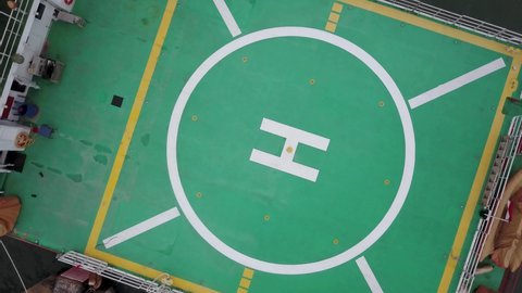 Aerial shot of a helipad with helicopter landing point. heliport on board a fire boat in Labuan Bajo port. Top down view