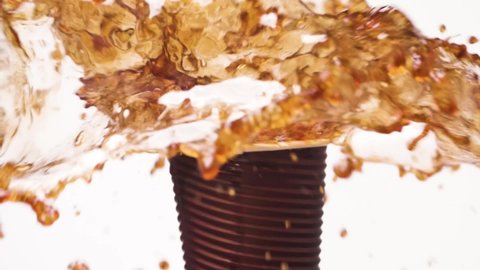 Close up spilling coffee in reverse mode. Drink splash on white background, rotation