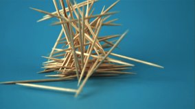 Super slow motion bunch of toothpicks falls on the table. On a blue screen. Filmed on a high-speed camera at 1000 fps.High quality FullHD footage - Powered by Shutterstock - Get 15% off with code: PIKWIZARD15