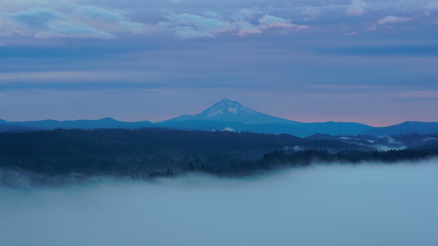 Ultra High Definition 4k Time Lapse movie of clouds rolling over Mount Hood and Sandy River Valley Oregon from Jonsrud viewpoint one foggy morning during sunrise USA America UHD