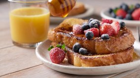 Pouring honey on french toast with berries. Sweet breakfast food - Powered by Shutterstock - Get 15% off with code: PIKWIZARD15